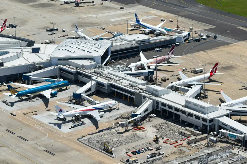 Aerial view of a busy airport terminal with aircraft at the gates